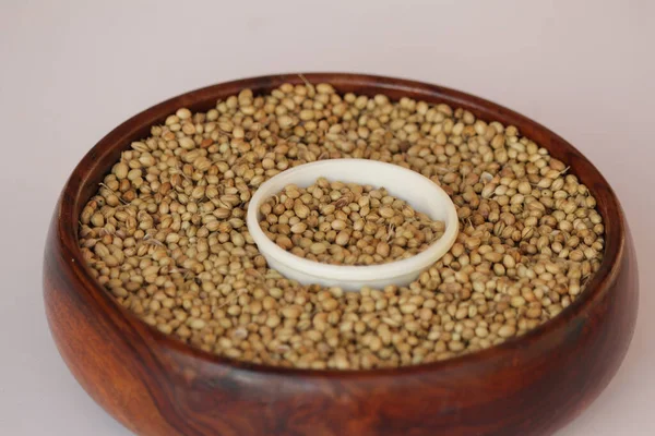 coriander in bowl on wooden background,Coriander seeds in a big wooden bowl,healthy eating,Indian spice,flavouring,selective focus,dried coriander seed bowl