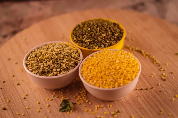 Green and yellow moong mung dal lentil pulse bean on black background, yellow Mung dal and green Moong bean rotation on wooden table, high protein moong dal