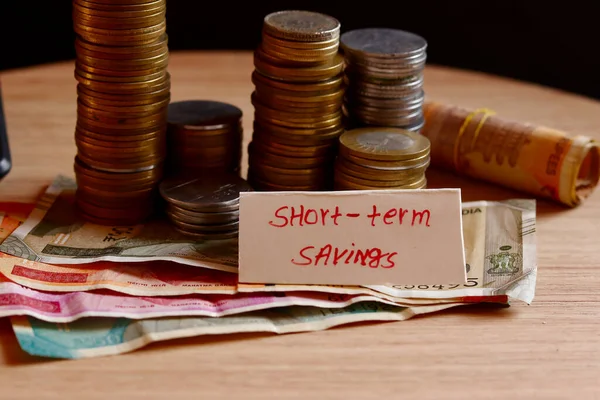 Short term saving writing and indian coin and cash(note) collection beautiful view, management of short Term saving, coin-cash rotation background with short Term saving