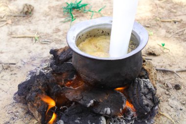 man making tea on dry cow dung,use of cow dung, indian tea making with cow dung,