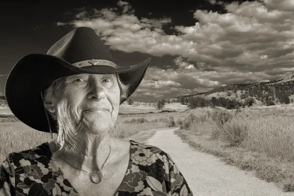 Senior lady wearing a black cowboy hat — Stock Photo, Image