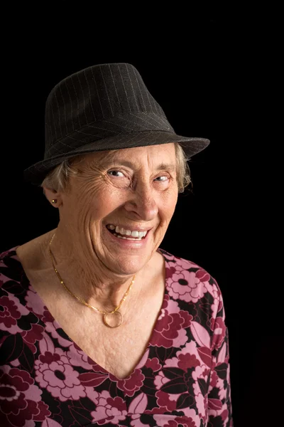 Senior lady wearing a fedora laughing — Stock Photo, Image