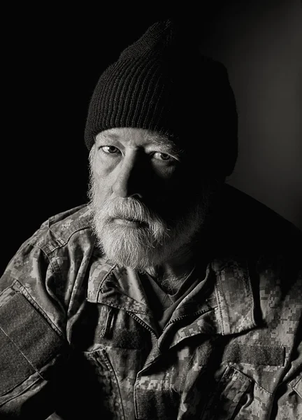 Serious Veteran wearing a camo jacket and knit hat — Stock Photo, Image