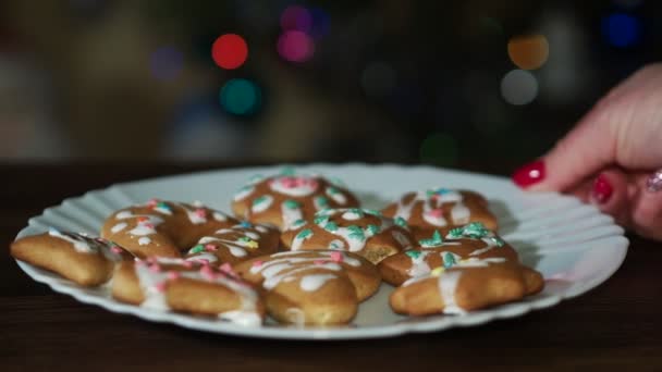 Holidays Woman Turns Plate Ginger Cookies Table Background Colored Lights — Stockvideo