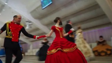 Novosibirsk, Russia, January,08,2022.Christmas Ball. Dancers in beautiful ballroom outfits dance in the ballroom under the camera flashes. Siberia.