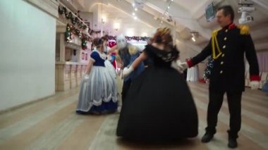 Novosibirsk, Russia, January,08,2022.Christmas Ball. Dancers in beautiful ballroom outfits dance in the ballroom under the camera flashes. Siberia.