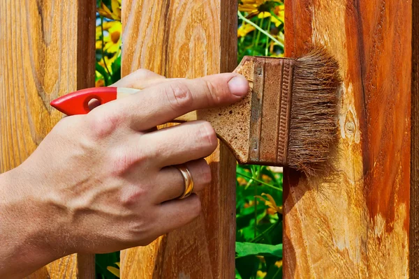 Painting the wooden fence — Stock Photo, Image