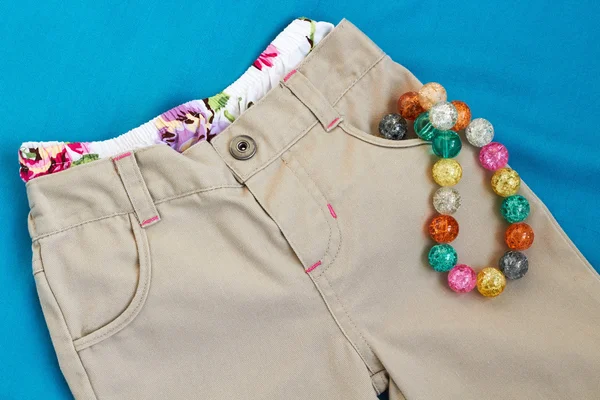 Girl's trousers with underpants and beads — Stock Photo, Image