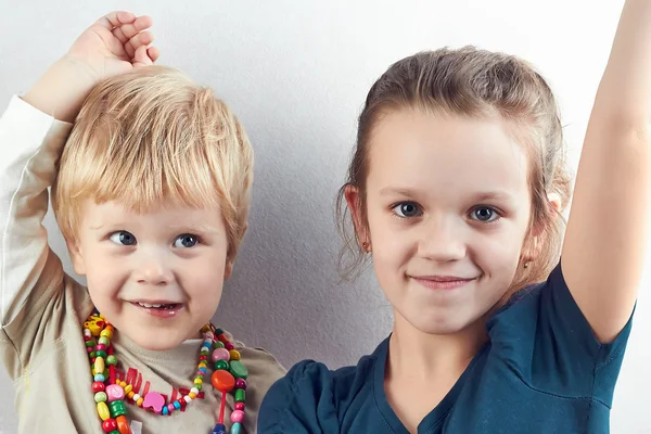 Small blond boy and girl pull hands up — Stock Photo, Image