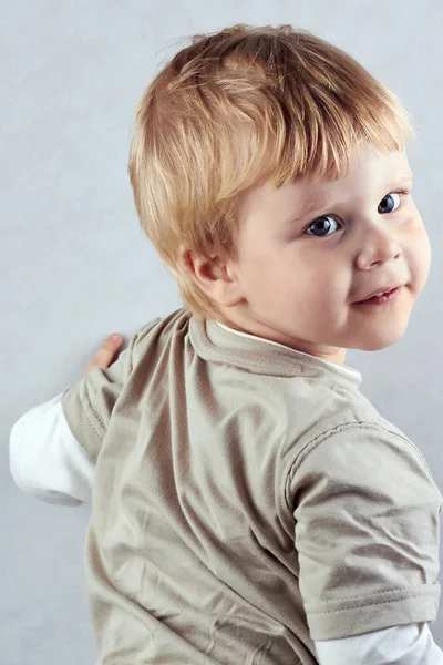 Vacker blond pojke står i halvt varv — Stockfoto