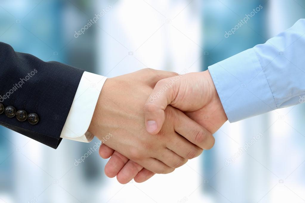 Close-up image of a firm handshake  between two colleagues