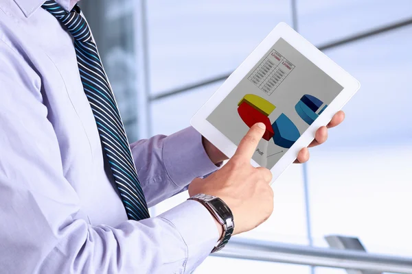 Empresário segurando um tablet digital e analisando as finanças — Fotografia de Stock