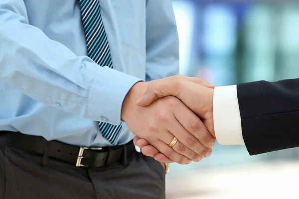 Close-up image of a firm handshake  between two colleagues in of — Stock Photo, Image