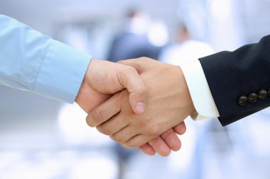 Close-up image of a firm handshake  between two colleagues on a