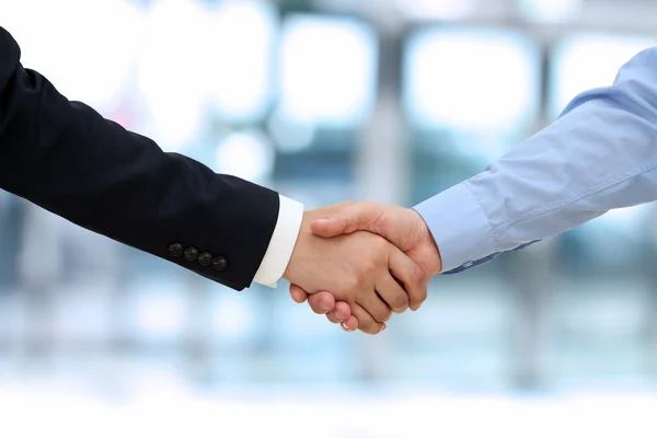 Close-up image of a firm handshake  between two colleagues in of — Stock Photo, Image