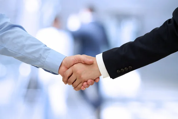 Close-up image of a firm handshake  between two colleagues in of — Stock Photo, Image