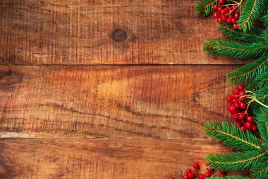 Noel arkaplanı. Dallar tahtadan bir arka planda potasyum ve kırmızı böğürtlen yedi. Üst Manzara. Noel ya da yeni yıl kartı. Çerçeve. Metin, kopyalama alanı, düz yatış, düzen için yer