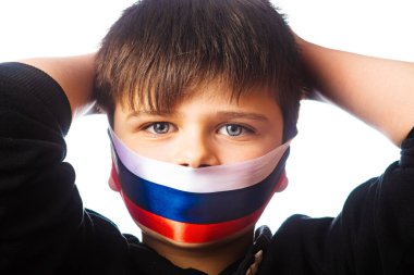 Clouse-up portrait of a boy covers his face with ribbons with flag of Russia. The escalation of Ukraine, the war. Confrontation between Ukraine and Russia clipart