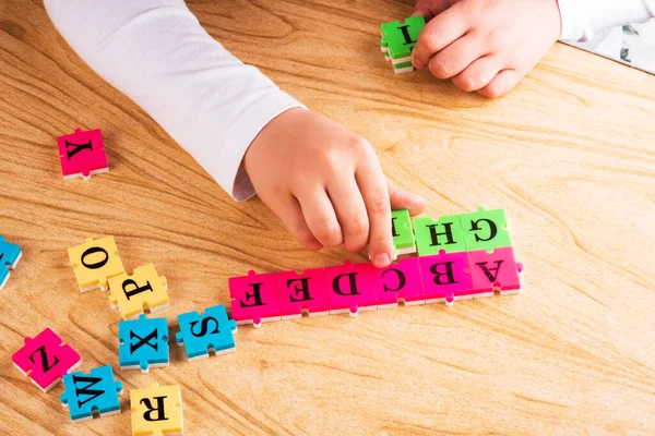 Top View Child Arm Learning Alphabet Puzzlein Table Copy Space — Stock Photo, Image