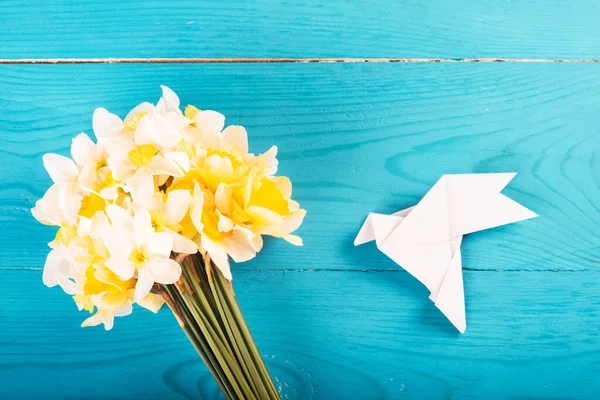 Yellow Daffodils Blue Wooden Background White Paper Dove Origami View — Stok fotoğraf