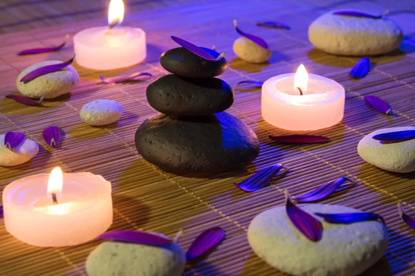 Black stones, and candles on mat bamboo — Stock Photo, Image