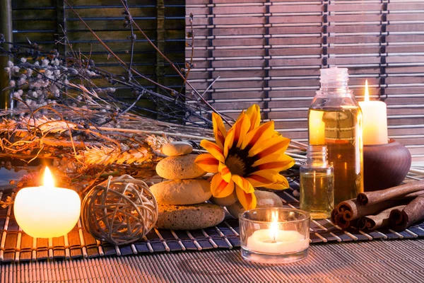 Candles, white stones, dried flowers, cinnamon, oil — Stock Photo, Image