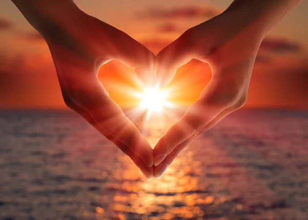 Sunset in heart hands — Stock Photo, Image