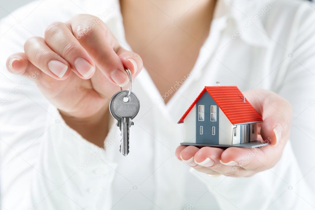 Real estate agent handing over keys to home