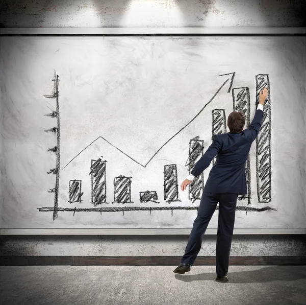 Businessman shows economic growth — Stock Photo, Image