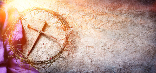 Passion And Crucifixion Of Jesus - Crown Of Thorns And Bloody Nails And Purple Robe On Ground With Sunlight And Selective Focus