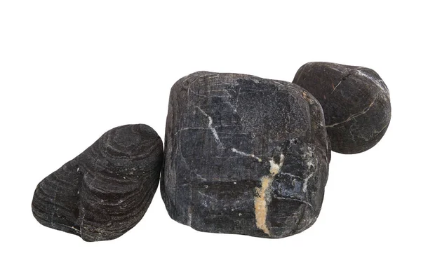 Nadir bulunan kabartma dokuya ve katmanlı yapıya sahip izole siyah taşlar, gölgeler olmadan yayılmış doğal ışıkla fotoğraflanmış..                   