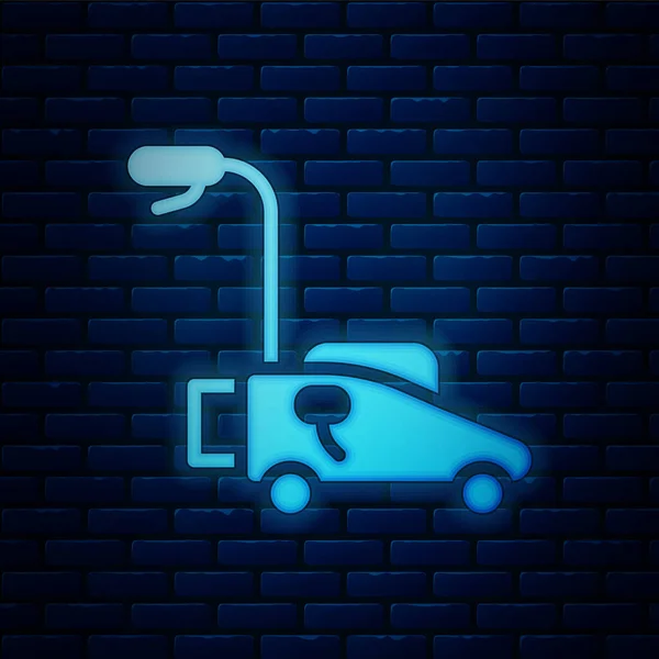 Glowing neon Lawn mower icon isolated on brick wall background. Lawn mower cutting grass. Vector — Stock Vector