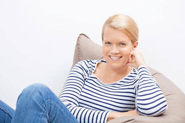 Woman sitting on a beanbag — Stock Photo, Image