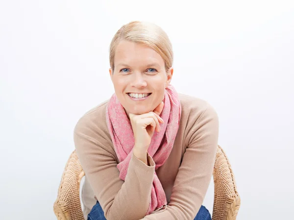 Woman sitting on a chair Stock Picture