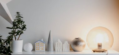 White candle dutch houses with ceramic christmas tree and glass round light lamp. Christmas home decorations. Happy holidays