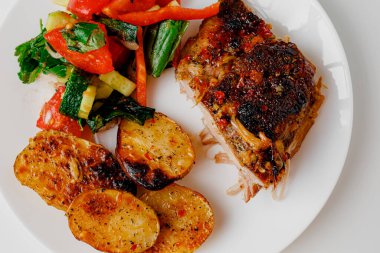 American food concept. Grilled pork ribs with grilled sauce, with smoke, spices and rosemary. Closeup of pork ribs grilled with BBQ sauce and caramelized in honey.