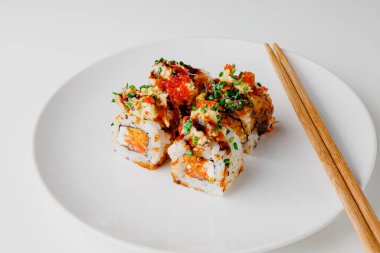 Japanese food: maki and nigiri sushi set. Sushi rolls with rice, fish salmon, smoked eel, avocado, cream cheese, soy Teriyaki sauce, sesame. Chopsticks, wasabi and Pickled Ginger.