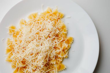Butterfly pasta four cheese. White plate, white background. Copy space. Thai food. Italian food.