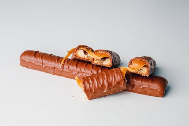 Chocolate bars with caramel isolated on white background. Delicious chocolate bars with cookies close up