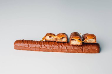 Chocolate bars with caramel isolated on white background. Delicious chocolate bars with cookies close up