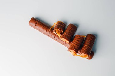 Chocolate bars with caramel isolated on white background. Delicious chocolate bars with cookies close up