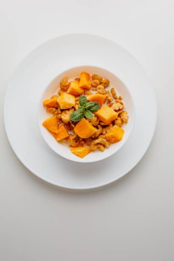 Tasty corn flakes with mango and leaves of mint on white background. Breakfast. Cornflakes with berry and milk. Cereal flakes. Fresh healthy food. Morning meal.