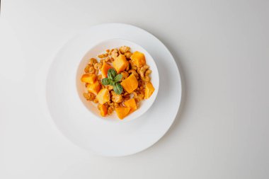 Tasty corn flakes with mango and leaves of mint on white background. Breakfast. Cornflakes with berry and milk. Cereal flakes. Fresh healthy food. Morning meal.