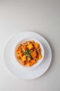 Tasty corn flakes with mango and leaves of mint on white background. Breakfast. Cornflakes with berry and milk. Cereal flakes. Fresh healthy food. Morning meal.