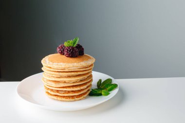 American pancakes with fresh blueberry, raspberry and honey. Healthy morning breakfast. Homemade American pancakes with Blackberries and golden honey. Healthy morning breakfast.