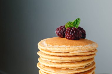 American pancakes with fresh blueberry, raspberry and honey. Healthy morning breakfast. Homemade American pancakes with Blackberries and golden honey. Healthy morning breakfast.