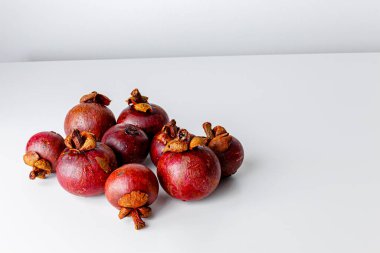 Mangosteens isolated on white background. Tropical fruits.