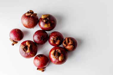 Mangosteens isolated on white background. Tropical fruits.