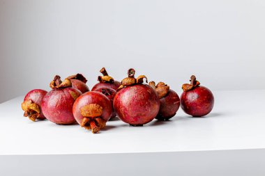 Mangosteens isolated on white background. Tropical fruits.