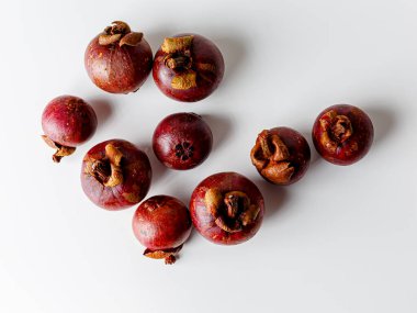 Mangosteens isolated on white background. Tropical fruits.